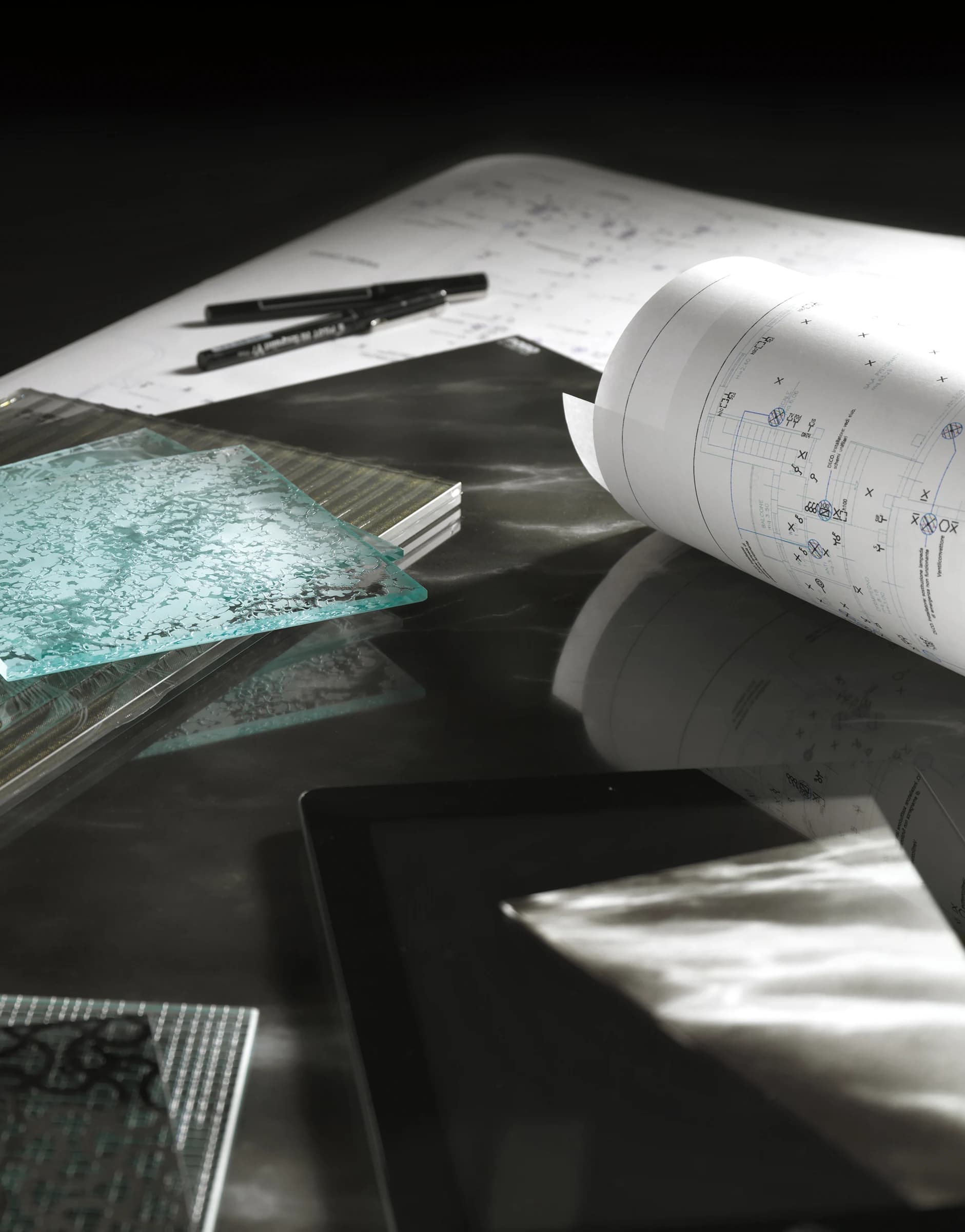 Textured glass samples, drawing tools and architectural plans