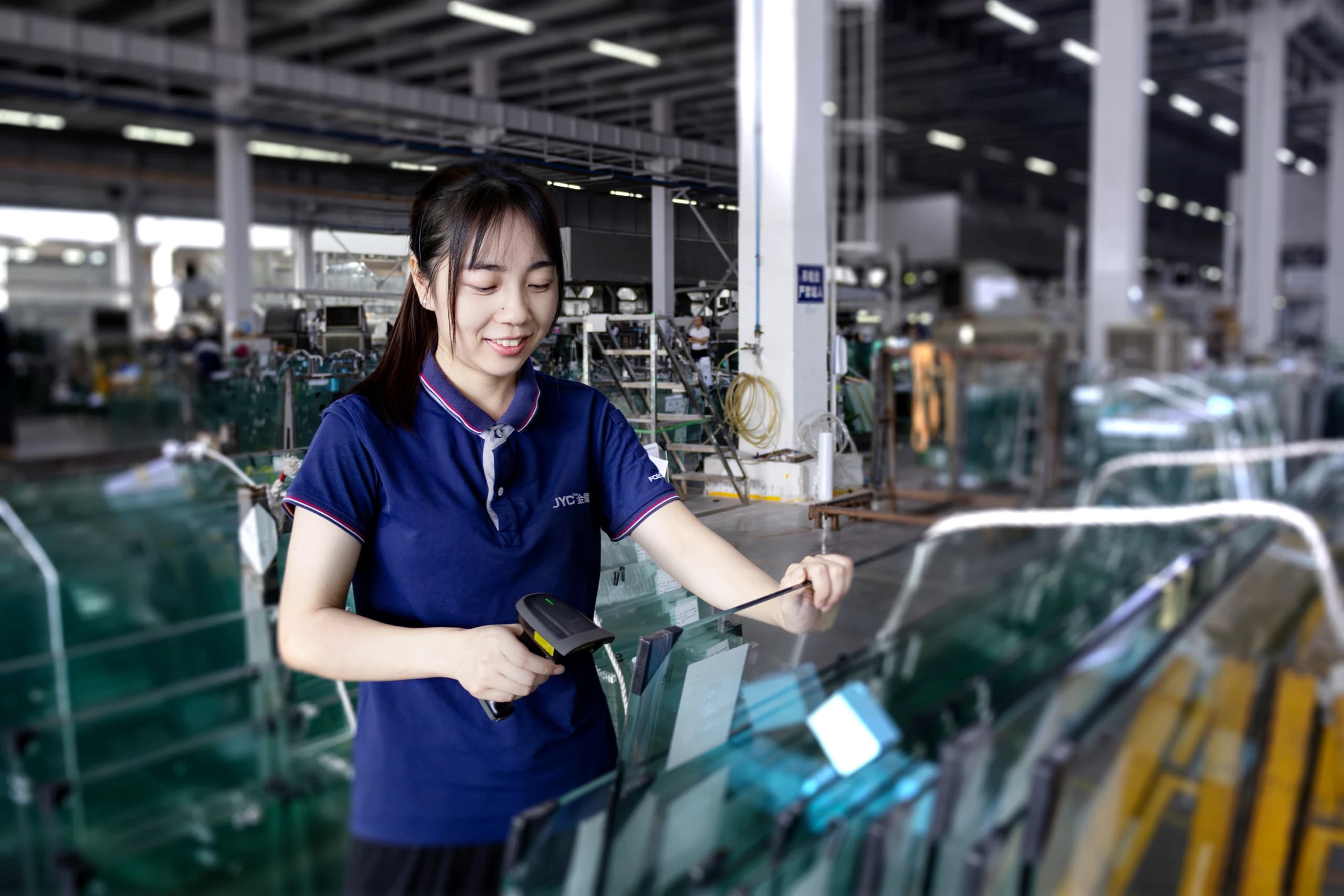 A member of the workshop team checking the edge of a panel