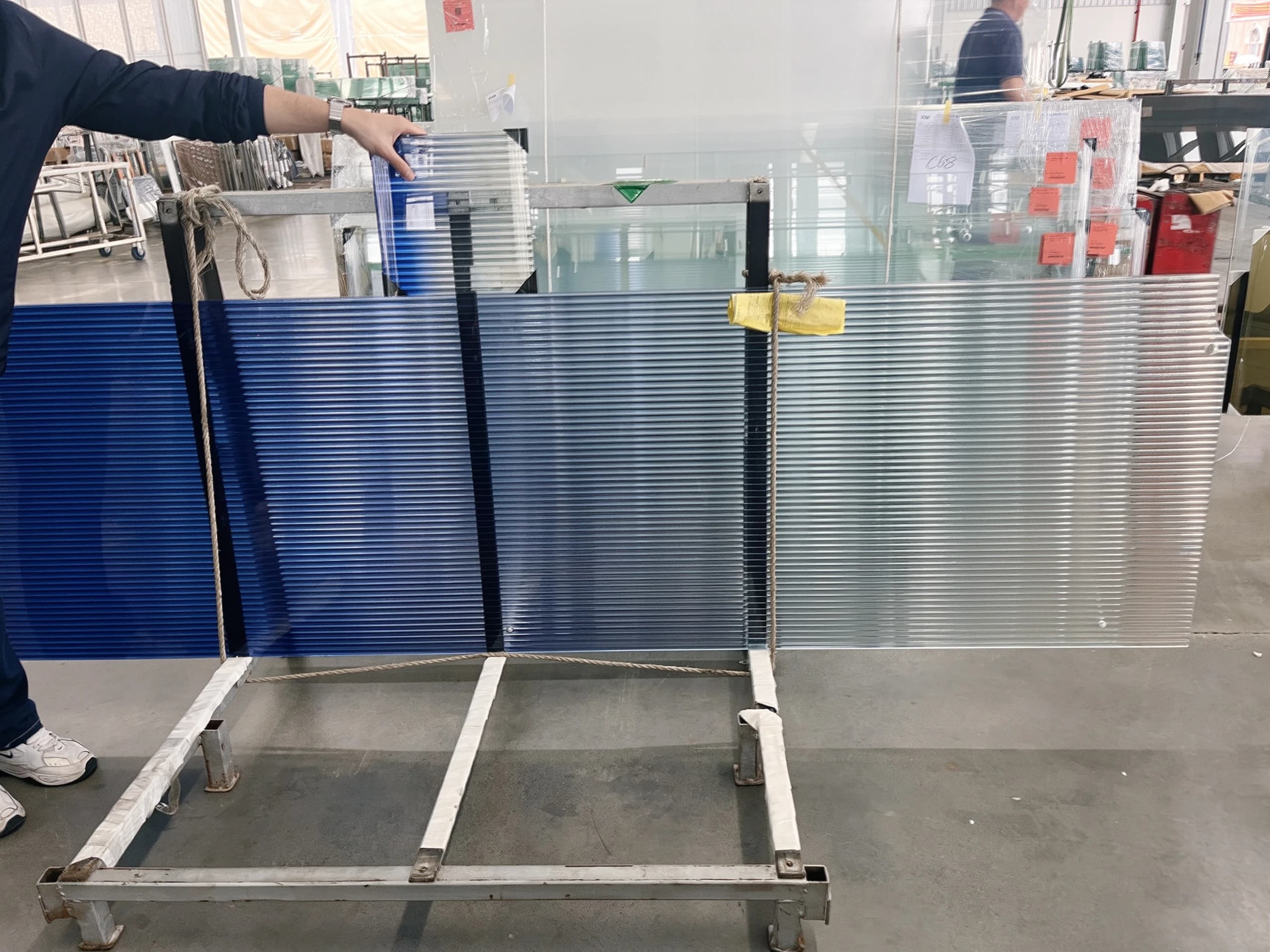 Blue gradient glass samples on a workshop rack