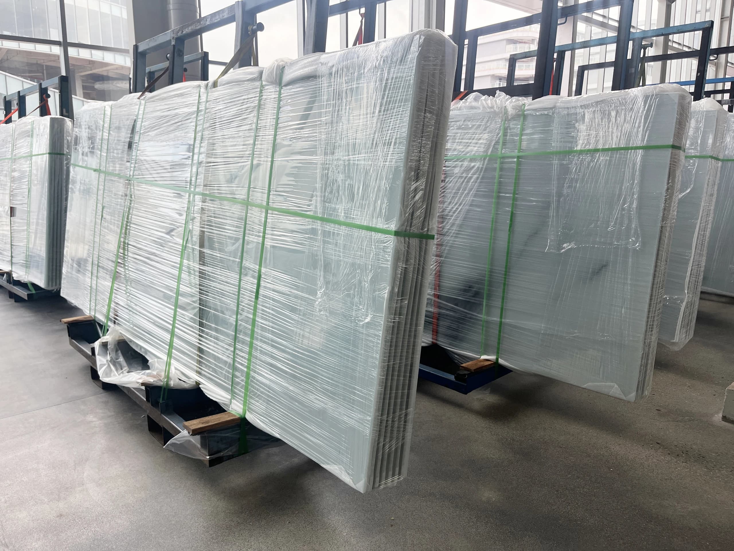 Wrapped panels held in transport racks