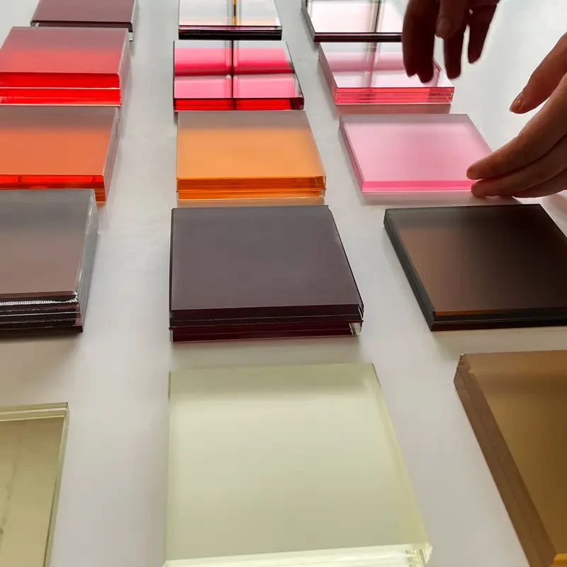 Rose, amber and muted coloured glass samples arranged for comparison