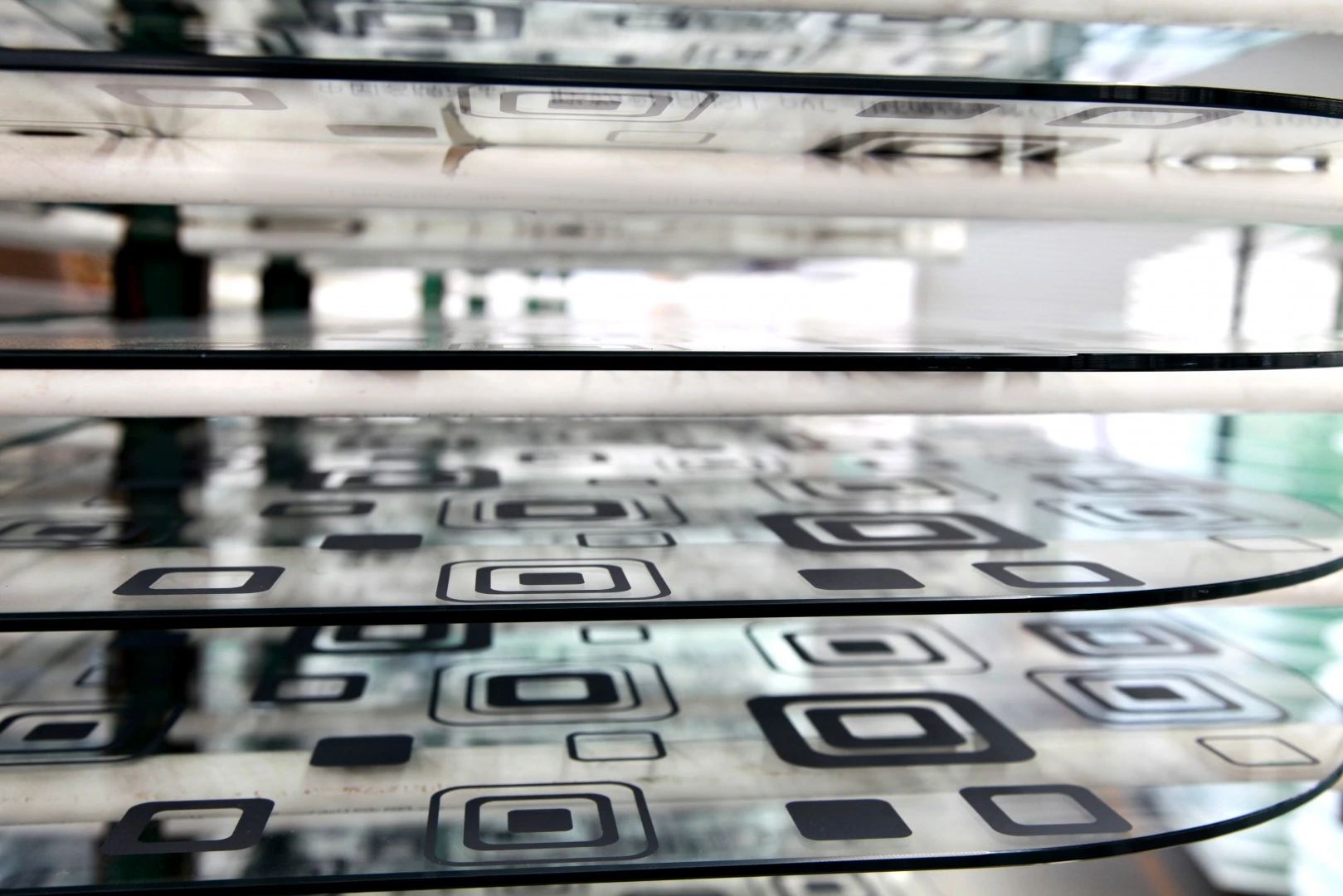 Repeated geometric motifs on a curved decorative glass surface